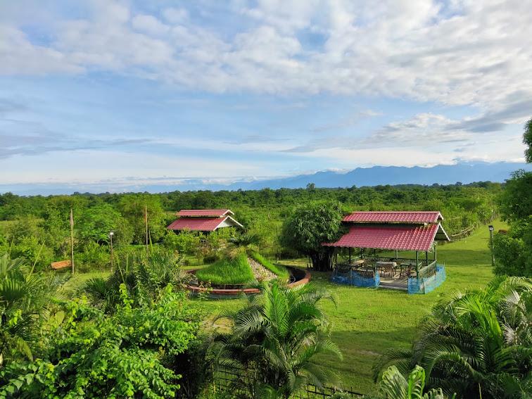 Garden cottages and lawn with the Bhutan hills beyond