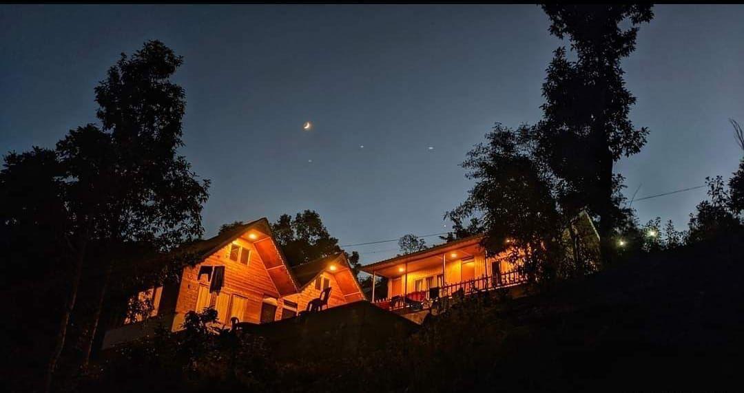 The villa lit up at night